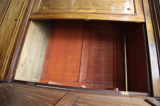 A matched pair of Regency style ebony strung mahogany wardrobes, W.4ft 4in. D.1ft 10in. H.7ft